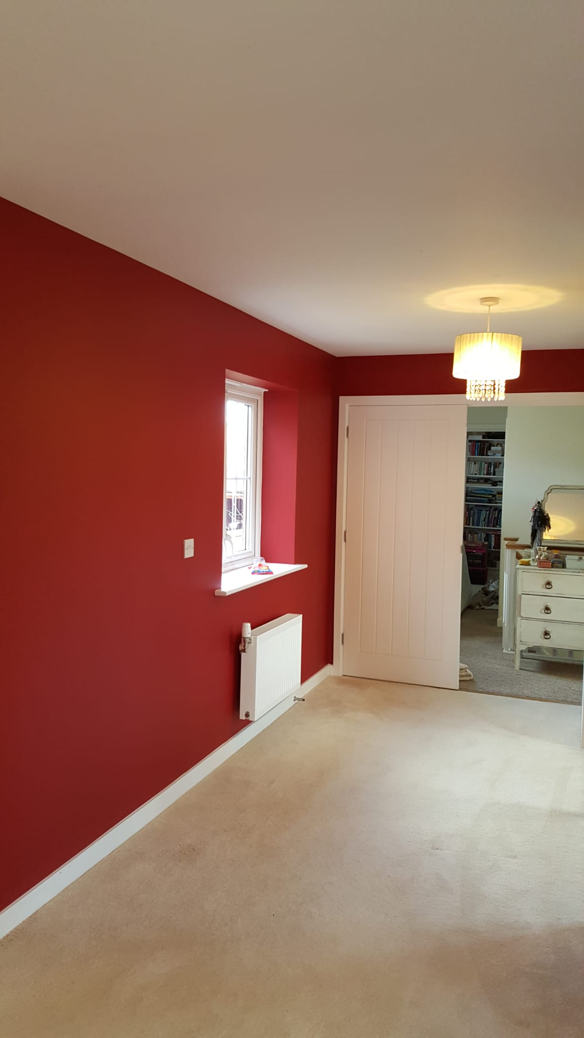 Bedroom with a bold red feature wall