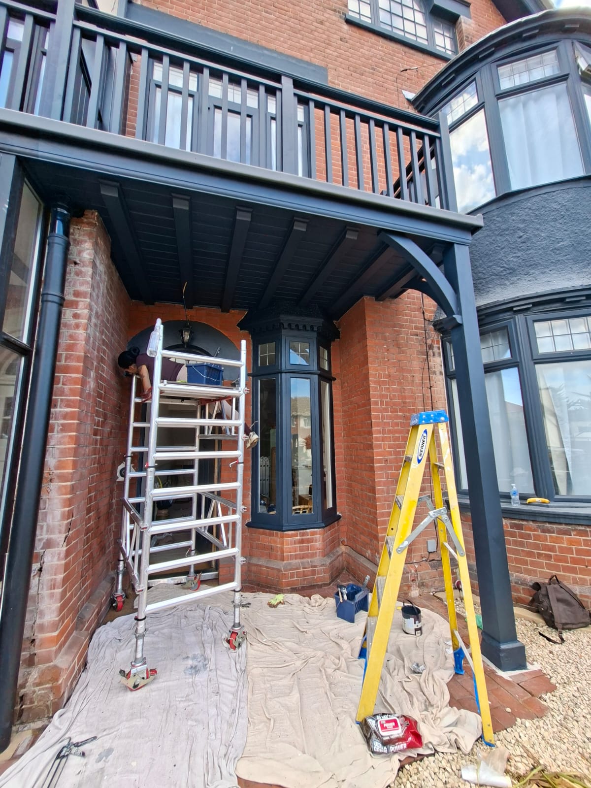 Scaffold tower set up beneath the first-floor balcony during restoration