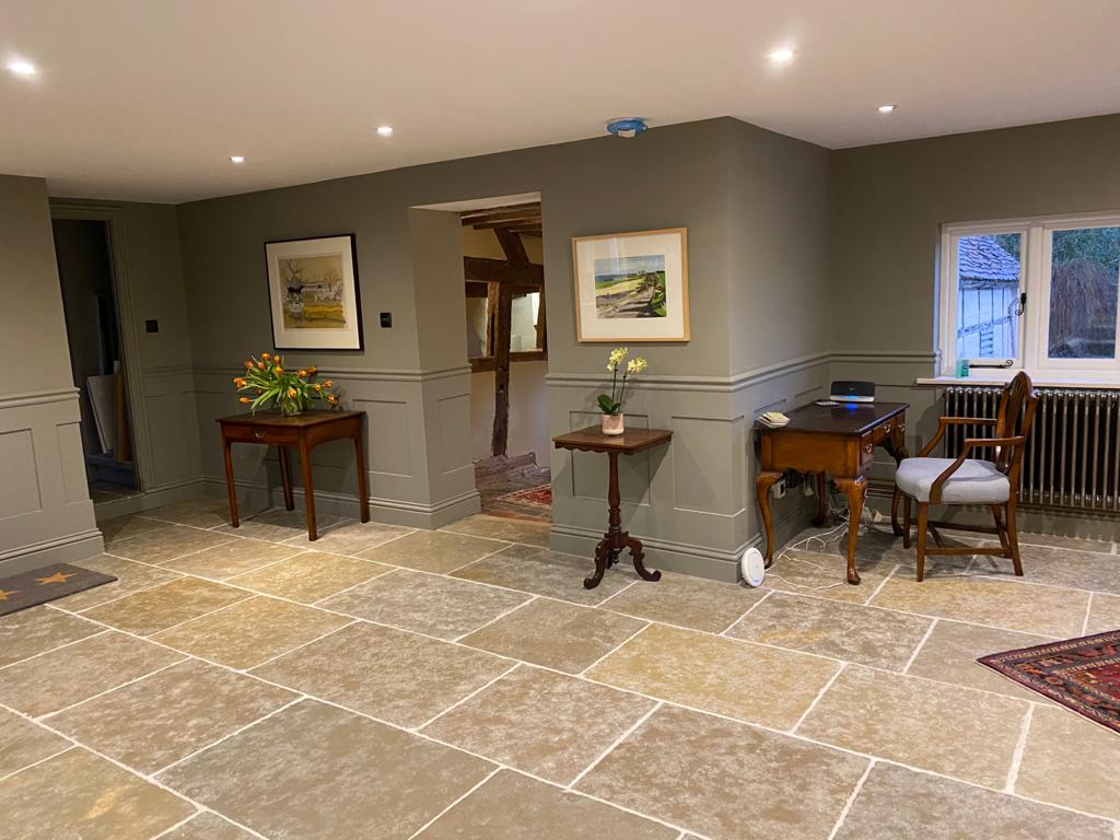 Elegant reception room with painted panelling and stone floor