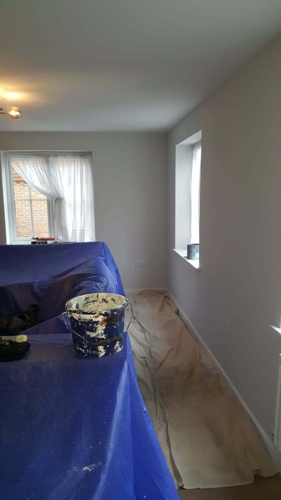 Corridor mid-decoration with a stepladder and paint tins